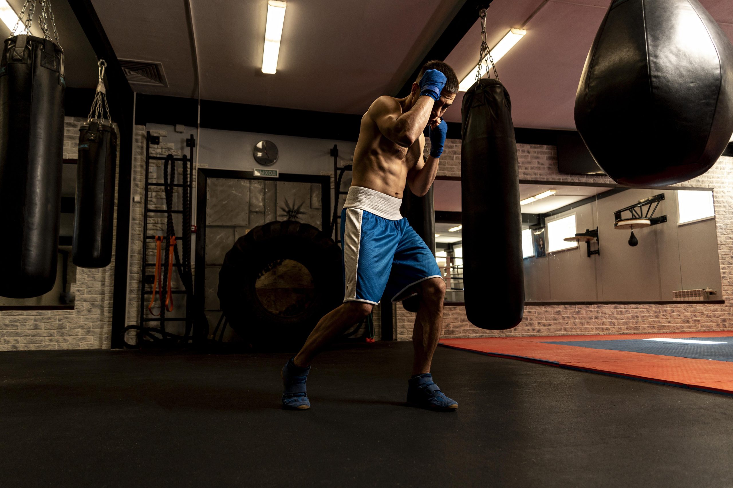 side view shirtless male boxer training